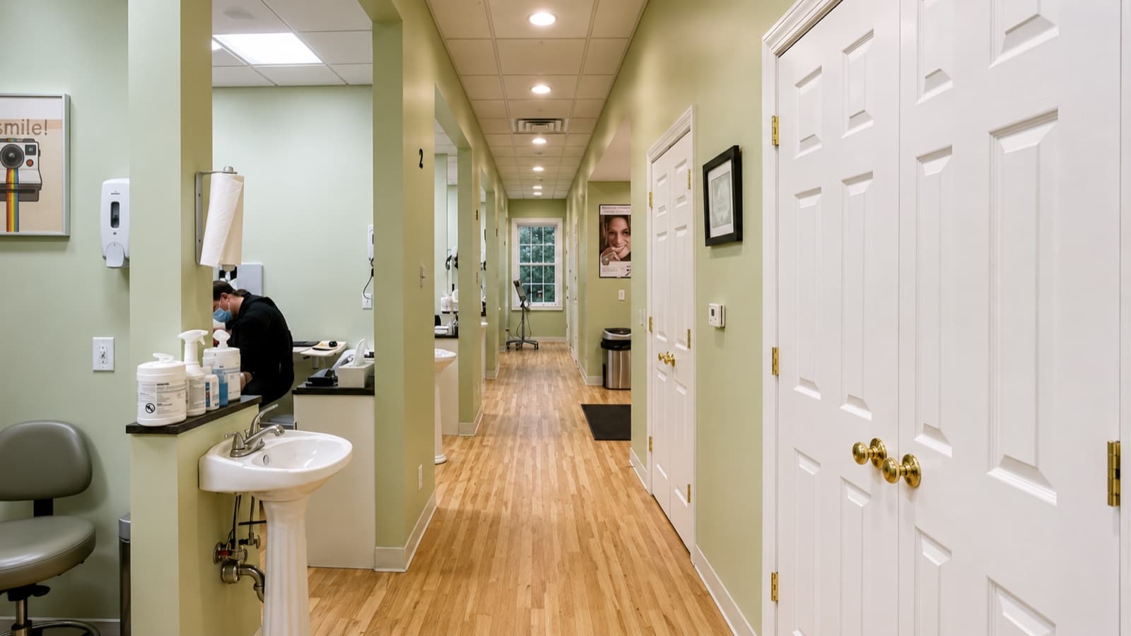 Bright hallway leading to treatment rooms with hygienist station on the left